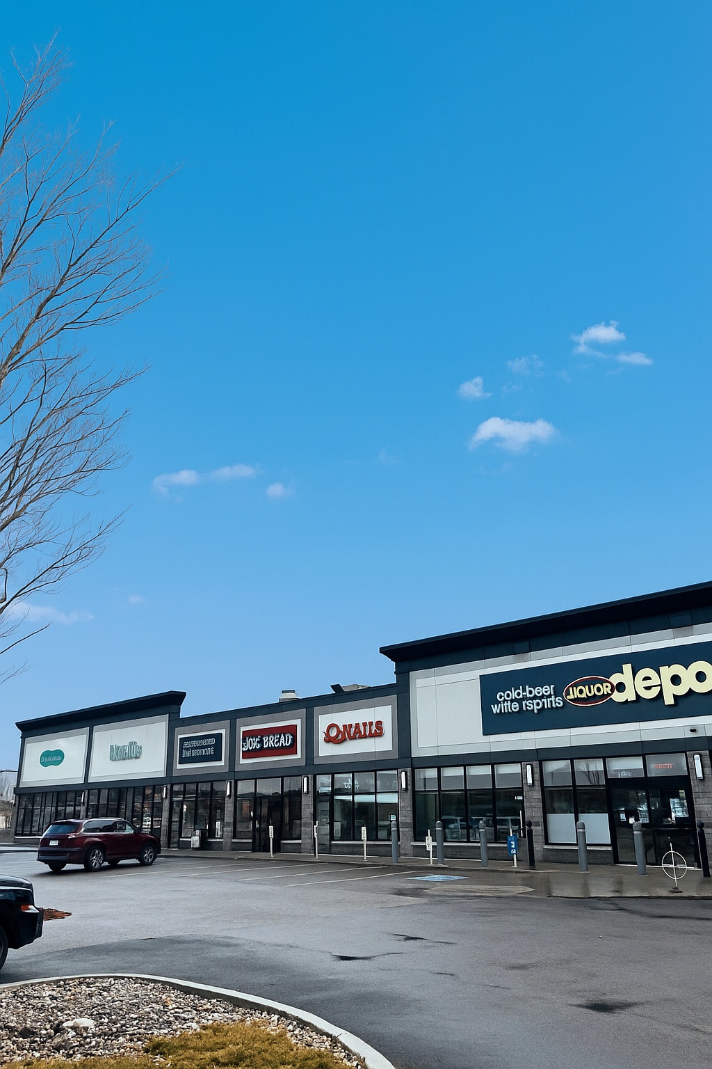 Exterior of Westgate Plaza showing the Q Nails storefront